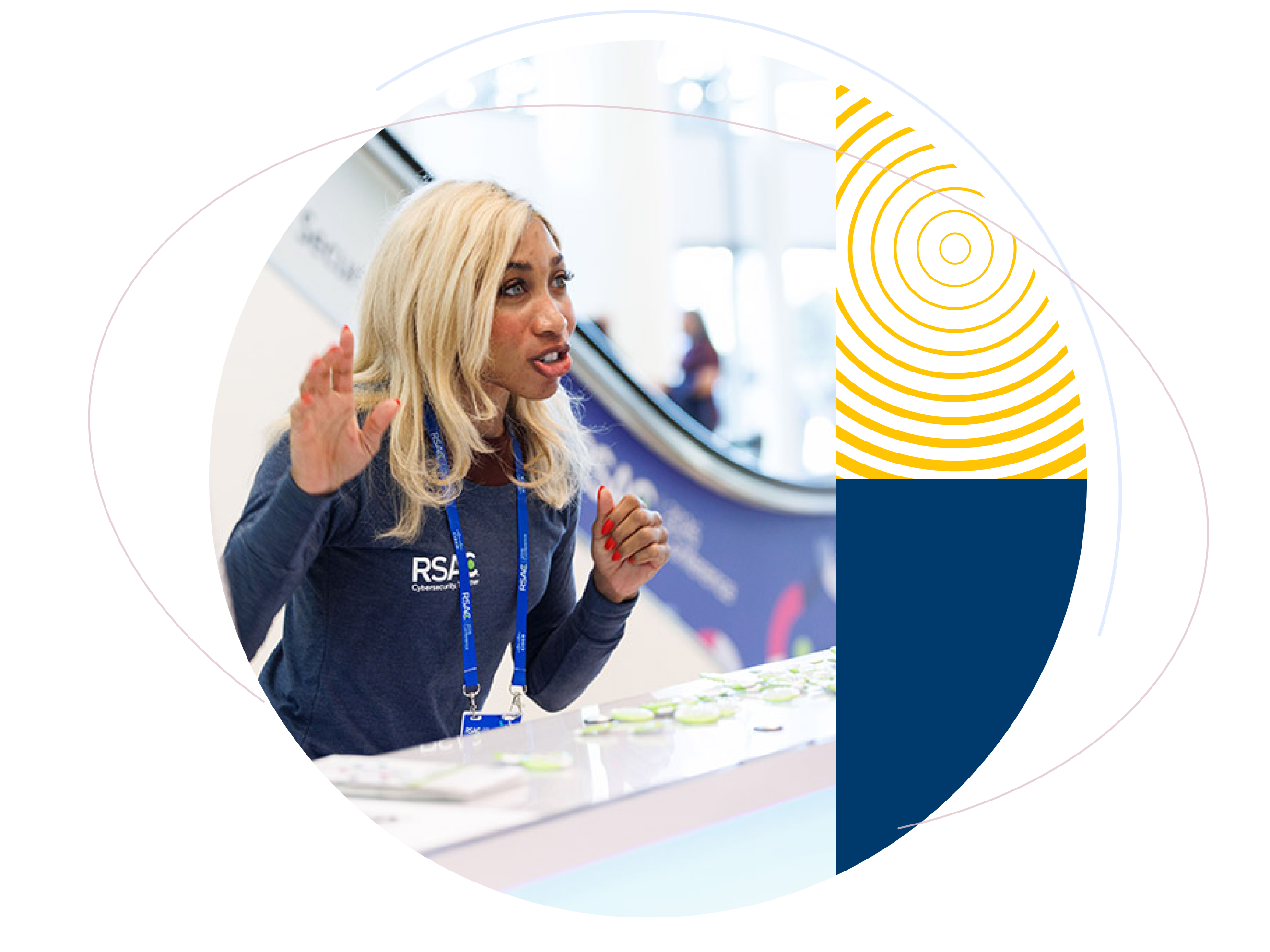 Blonde woman wearing an RSAC shirt and conference lanyard speaking enthusiastically at an event booth, framed by colorful circular graphics.