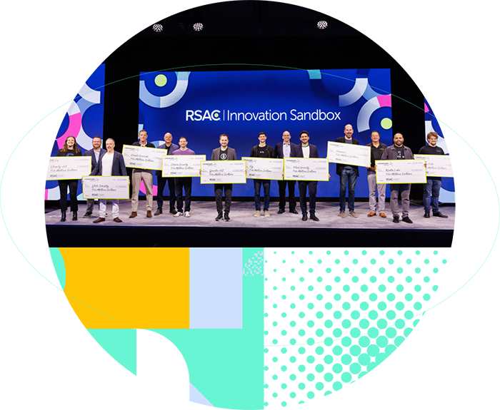 RSAC Innovation Sandbox participants standing on stage holding oversized award checks, surrounded by colorful geometric shapes.