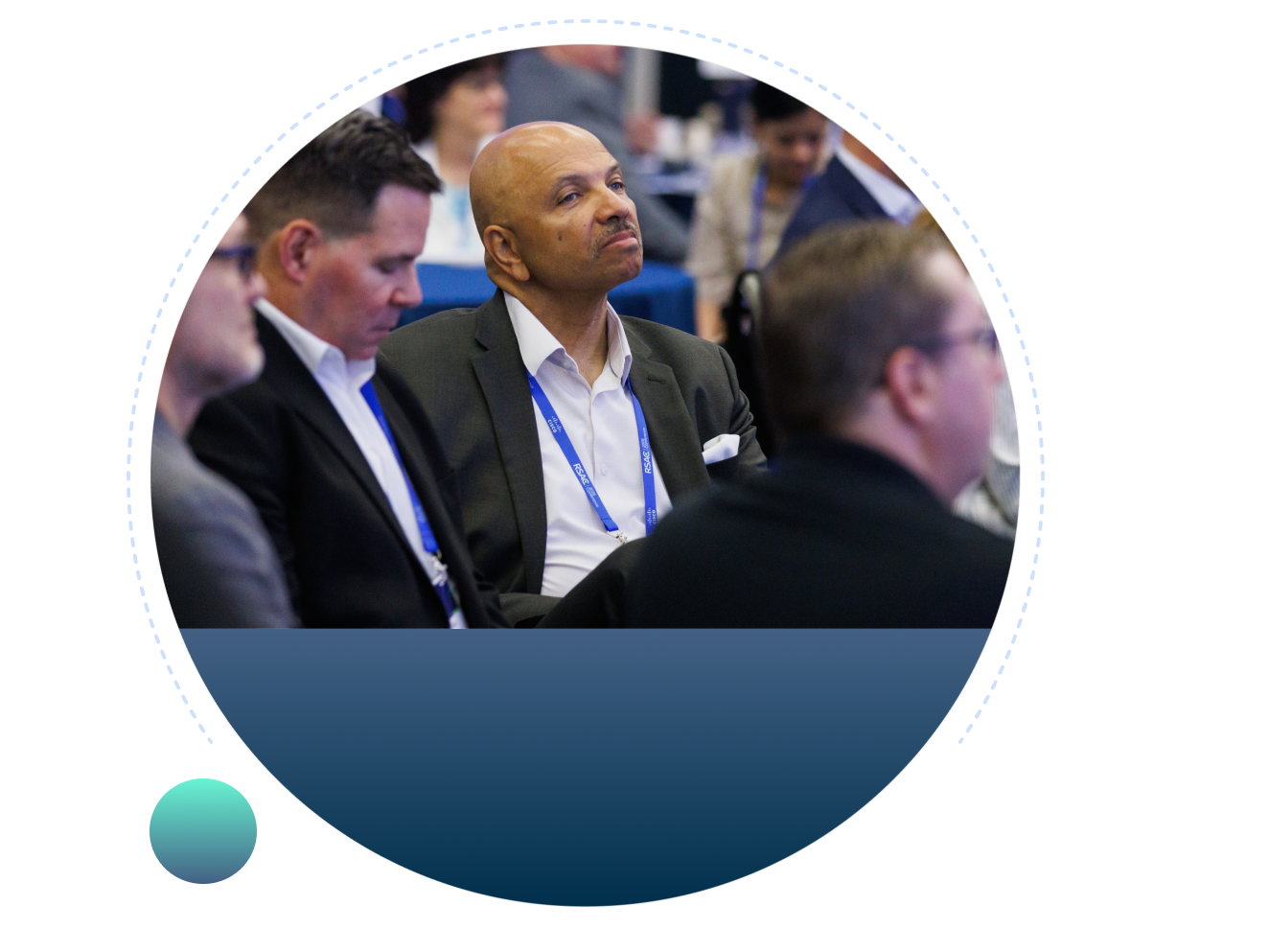 Attendees seated at an RSAC conference session, with a man in a dark suit and blue lanyard listening attentively, framed by a circular navy blue graphic.