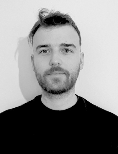 Athanasios Theocharis: Black-and-white headshot of Athanasios Theocharis wearing a black shirt against a light background.
