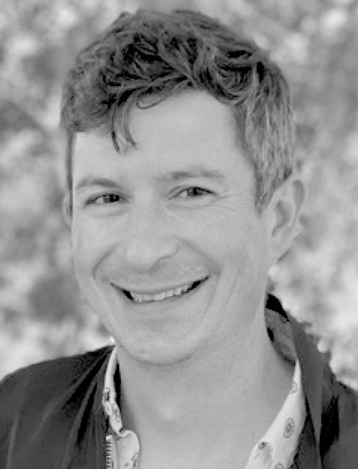 Dan Marino: Black-and-white headshot of Dan Marino smiling in a dark jacket and collared shirt.