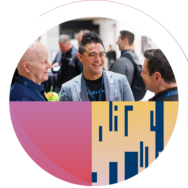 Three cybersecurity professionals smiling and networking at a conference, framed by pink, yellow, and navy geometric patterns.