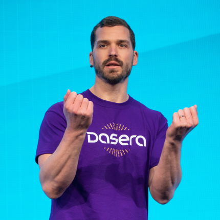 Male speaker wearing a purple Dasera T-shirt presenting on stage, representing the 2020 RSAC Launch Pad finalist acquired by Netskope.